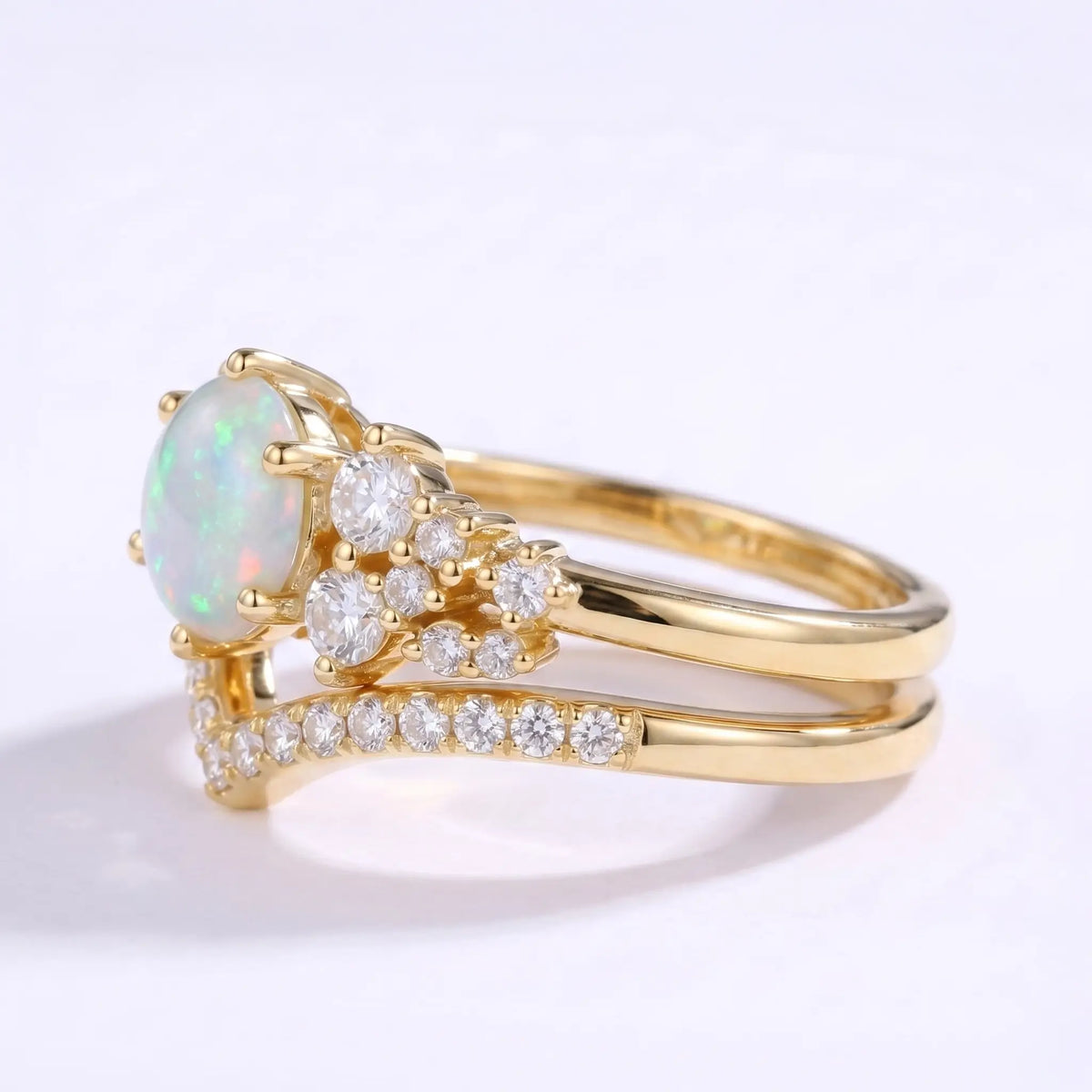 Left view of round opal bridal set with cluster accents and curved stacking band