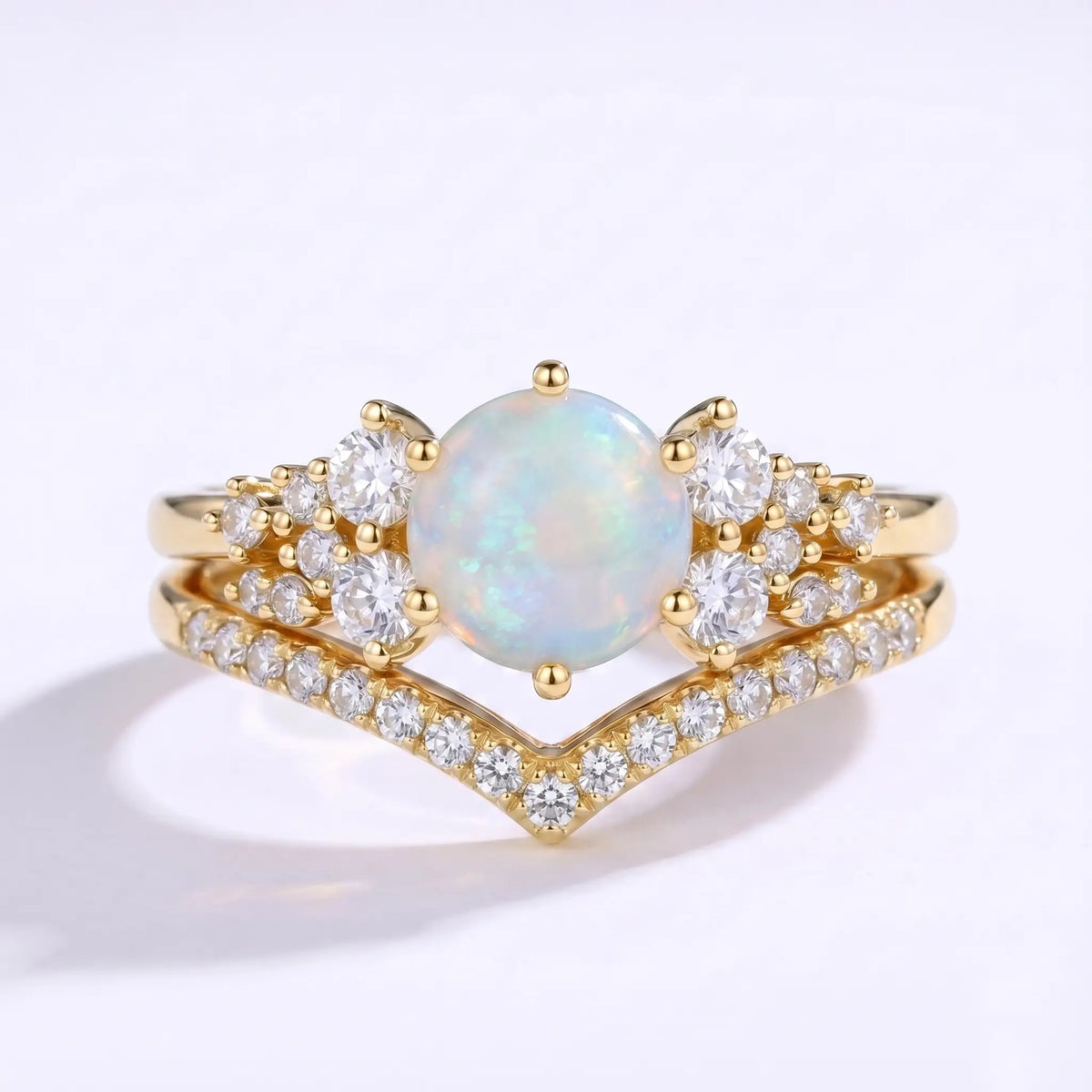 Round opal cluster engagement ring set with a V-shaped moissanite band in yellow gold