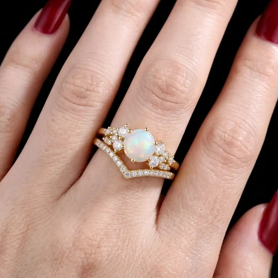 Round opal cluster ring set worn on hand with a matching V-shaped band