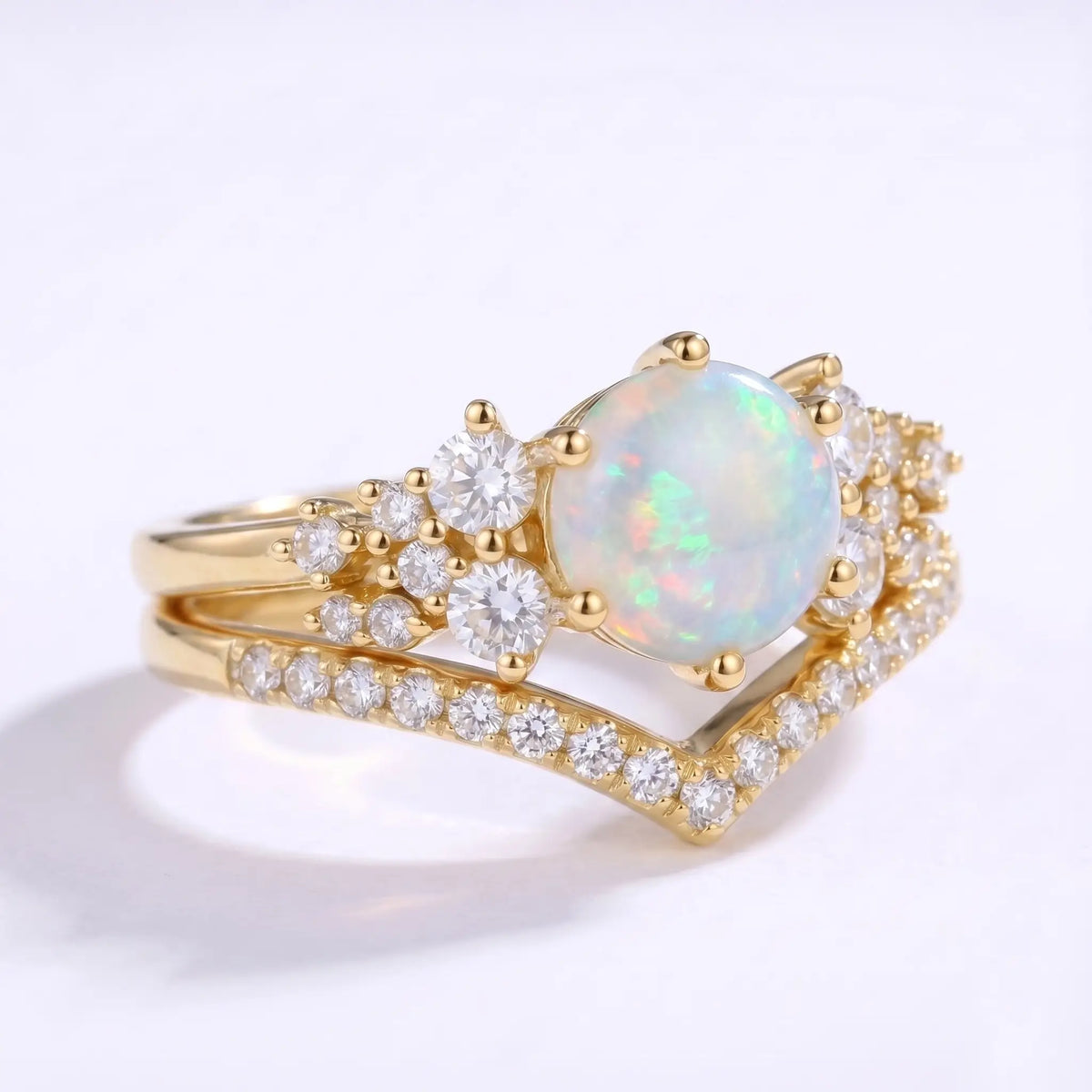 Side view of opal engagement ring set showing layered V-shaped band design