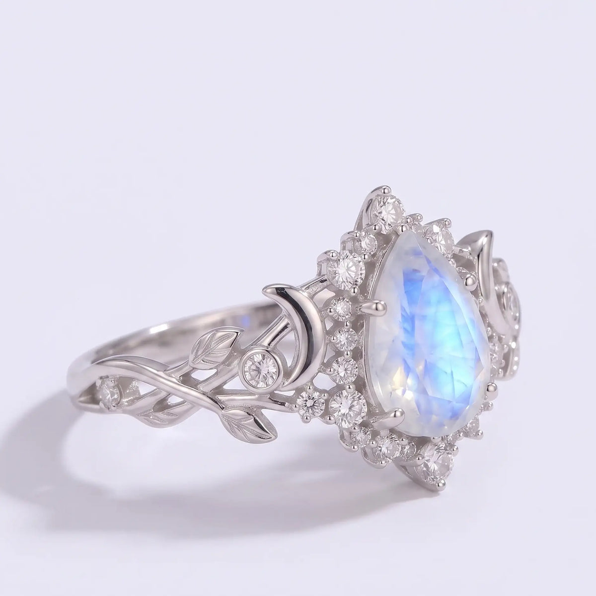 Nature inspired moonstone engagement ring with engraved leaves
