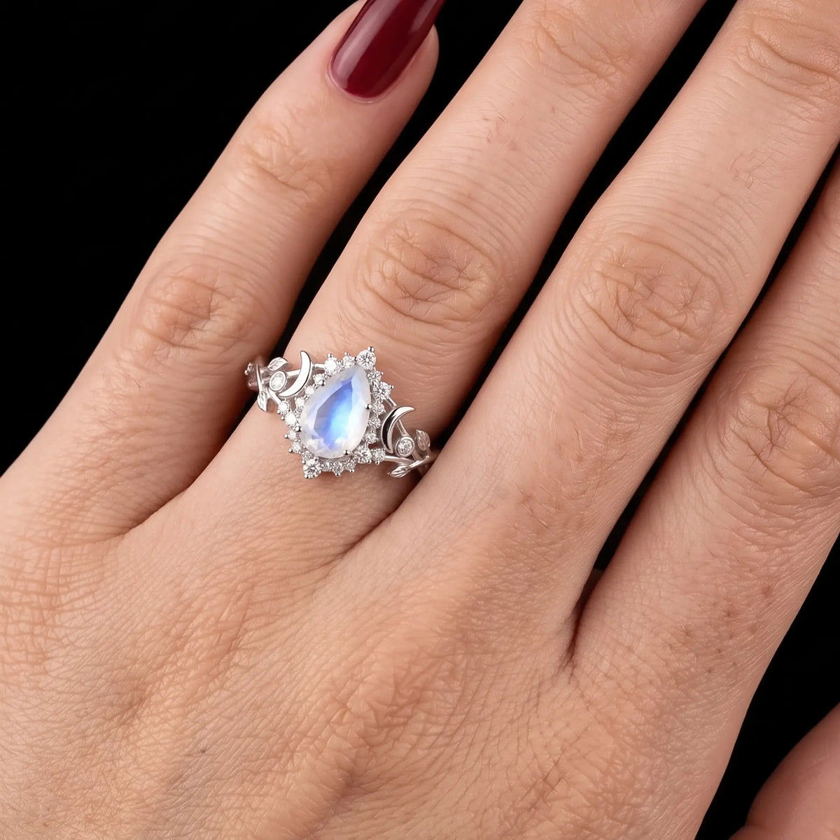 Pear moonstone crescent moon engagement ring worn on hand for ladies anniversary gift
