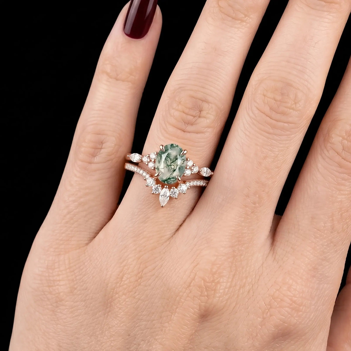 Modern high luxury natural oval moss agate cluster stacking bridal ring set shown on a finger