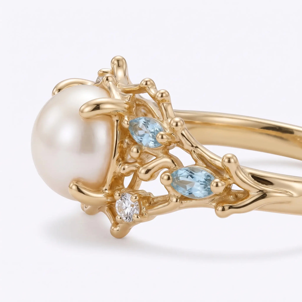 Side view of ocean inspired pearl ring with sculpted marine details