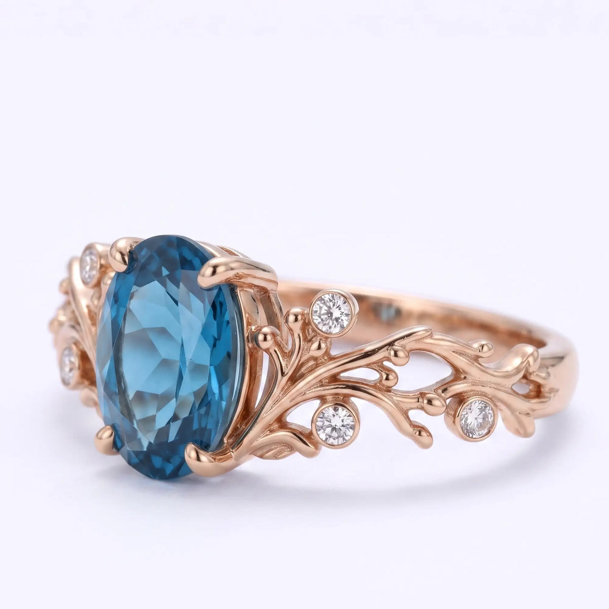Coral design ring with oval London blue topaz and round moissanite accents