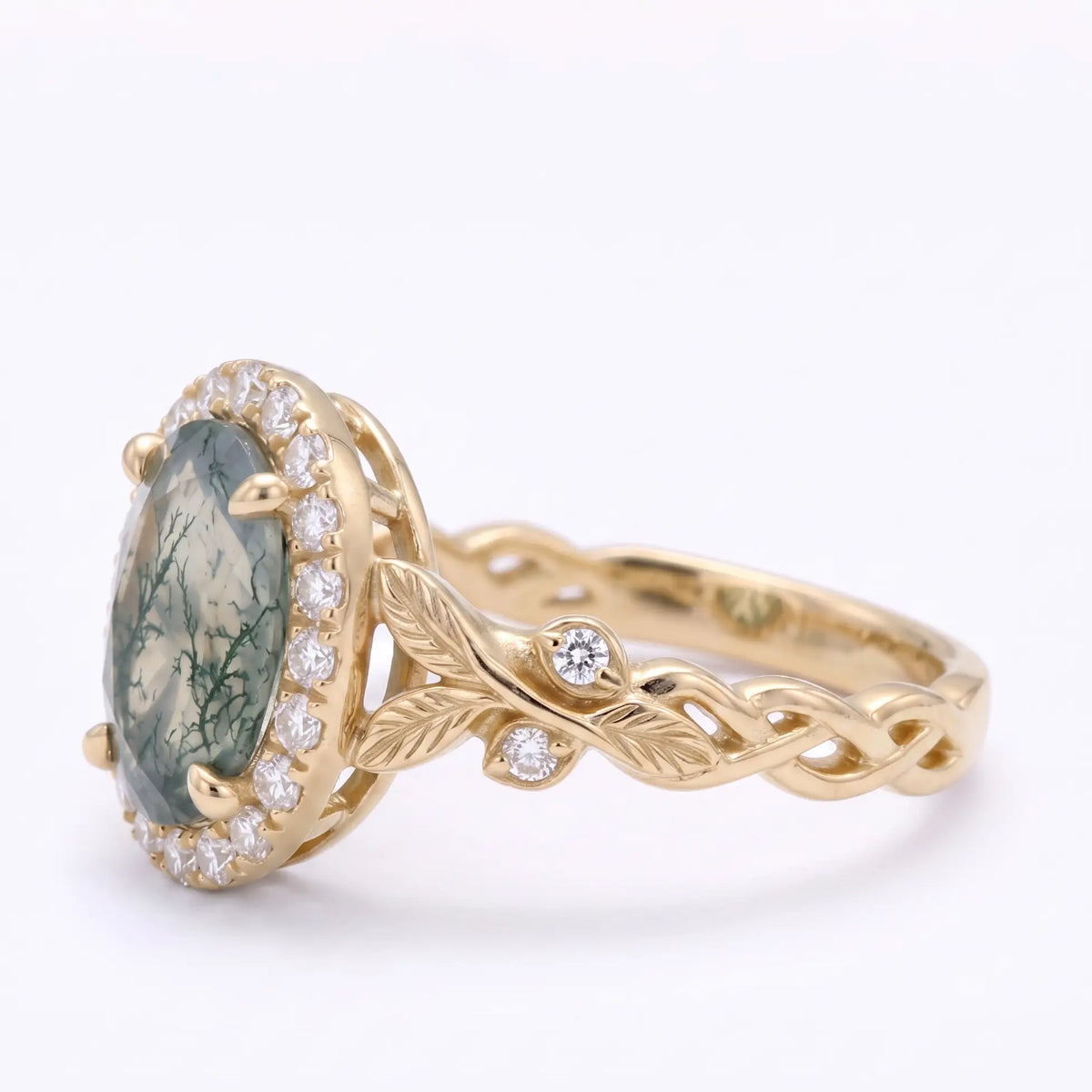 Left angle of nature inspired moss agate halo ring with sculpted gold leaves