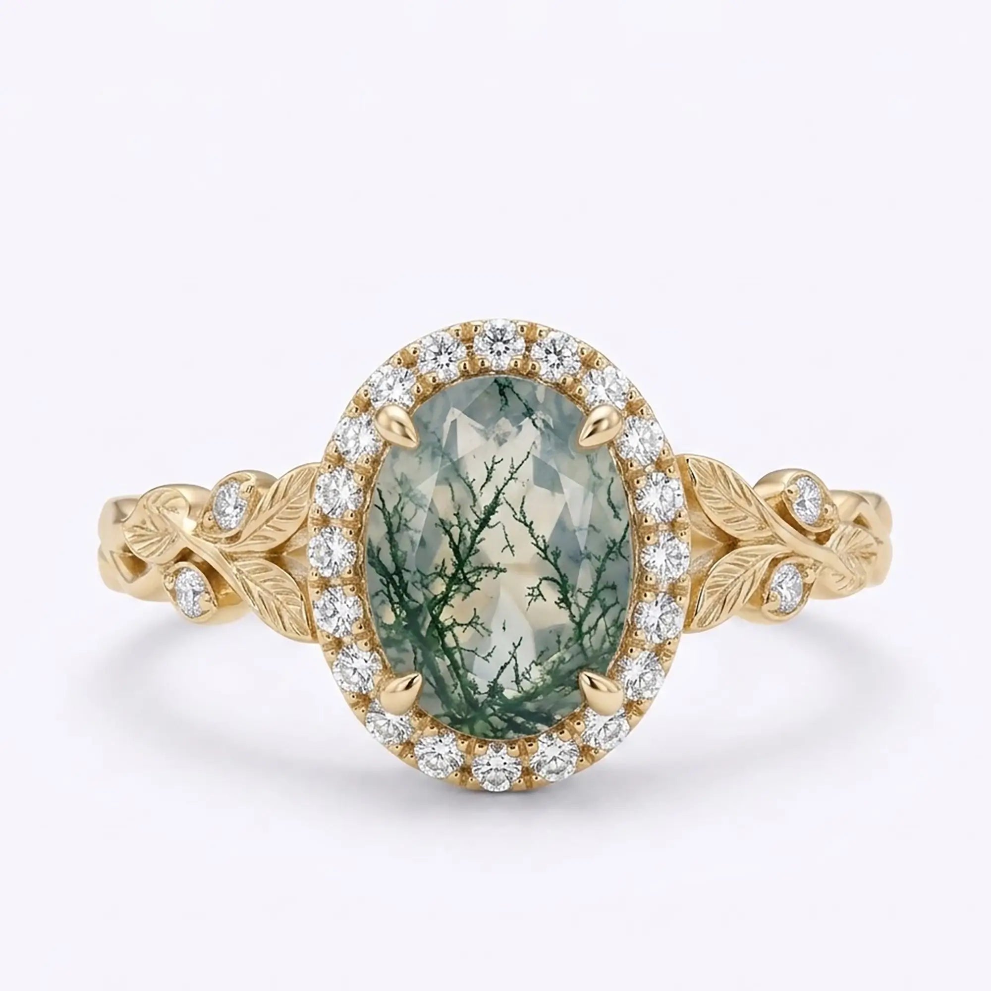 Oval moss agate halo engagement ring with botanical leaf details in yellow gold