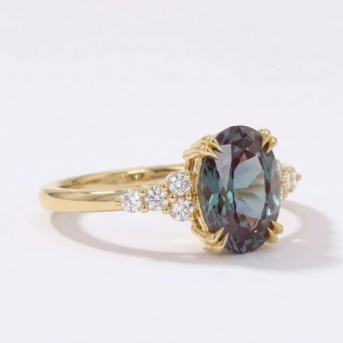 Side profile view of a thin solid gold alexandrite ring showcasing low-profile cluster architecture and flush alignment