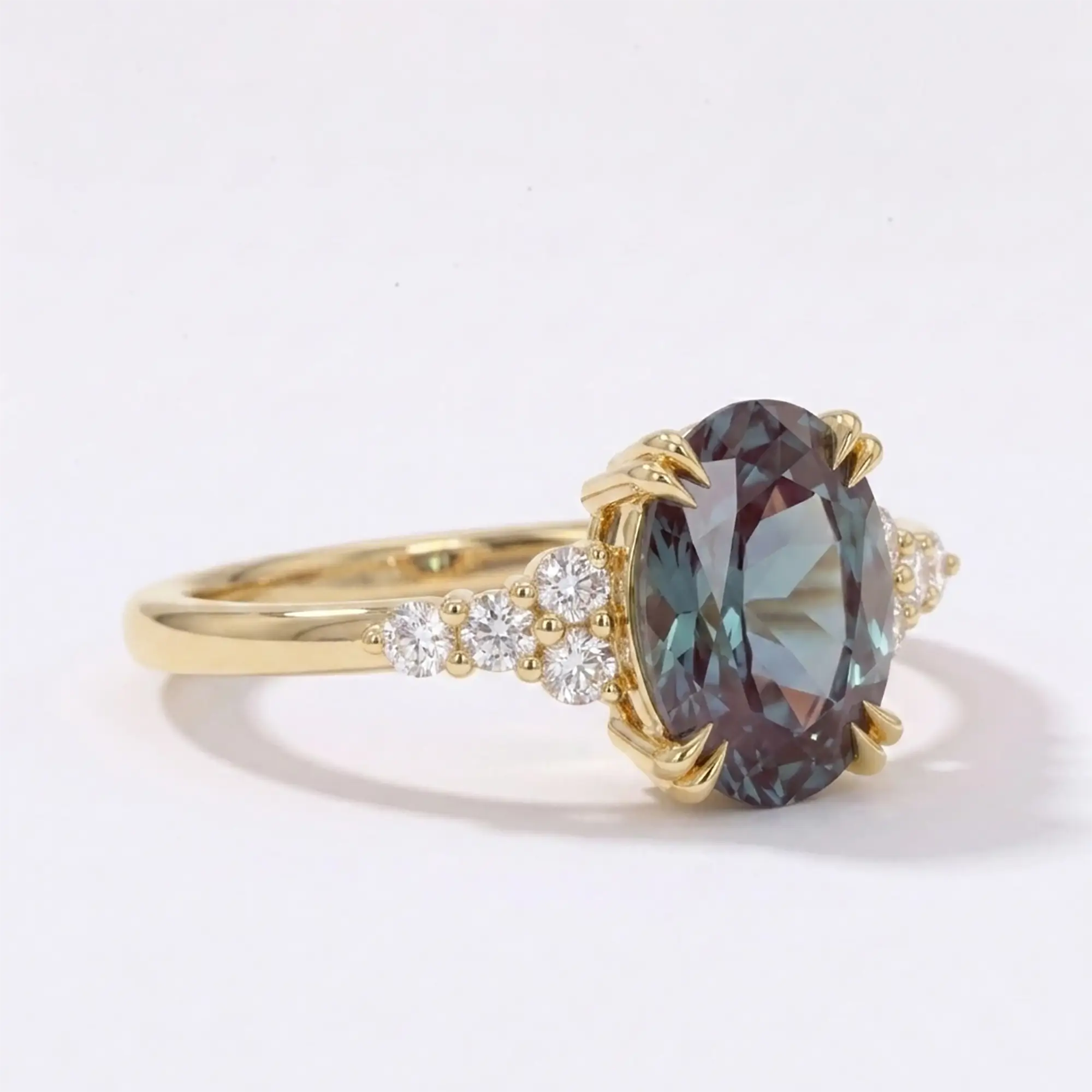 Side profile view of a thin solid gold alexandrite ring showcasing low-profile cluster architecture and flush alignment
