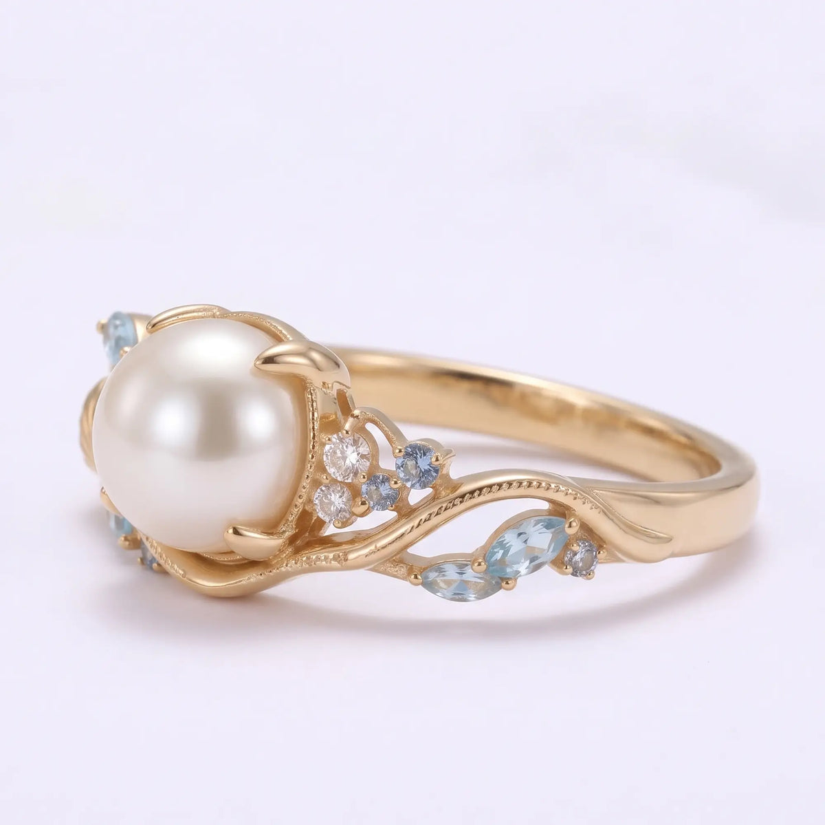 Side view of ocean inspired pearl engagement ring with flowing asymmetrical gold lines