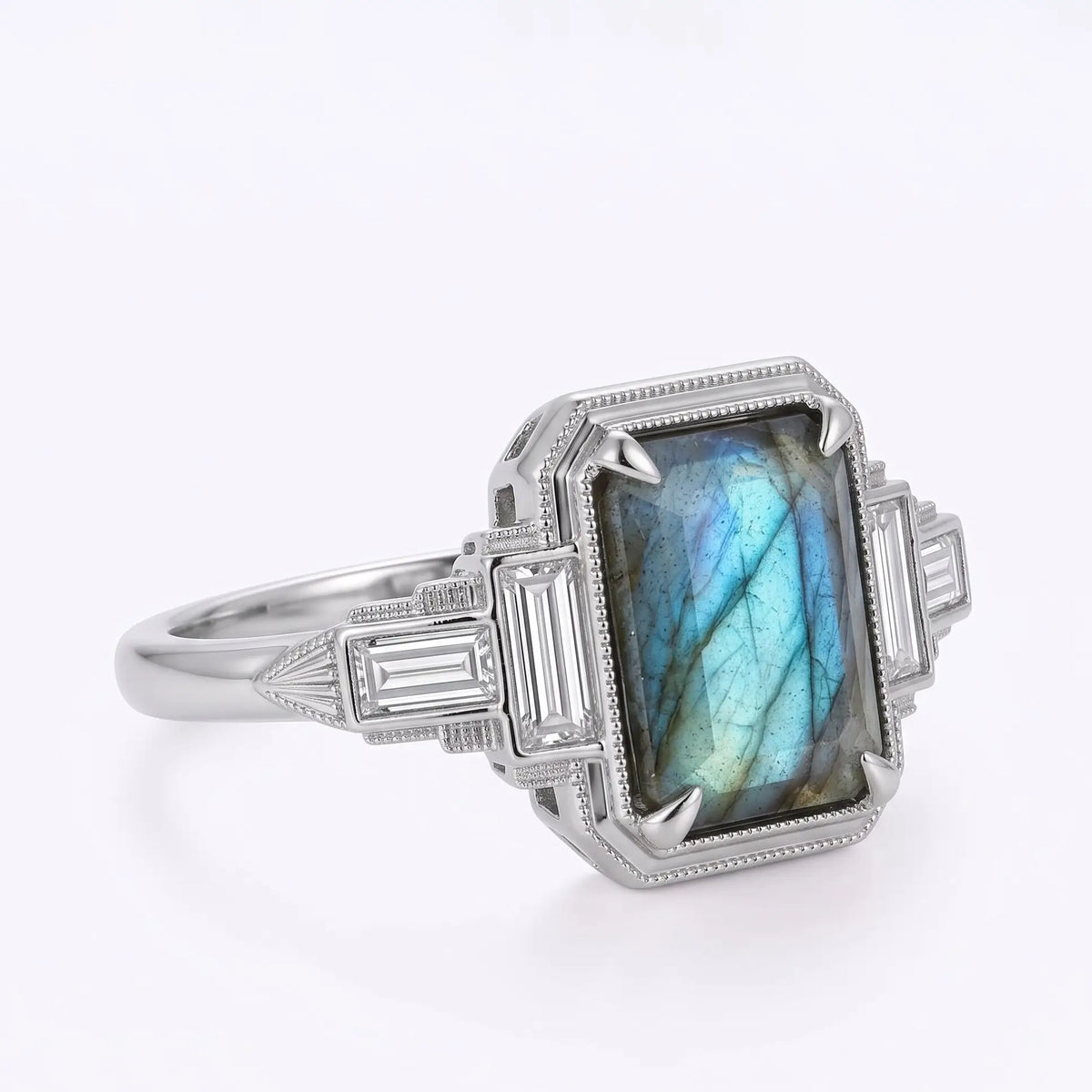 Three quarter view of vintage labradorite engagement ring with blue green gemstone flash and Art Deco white gold setting