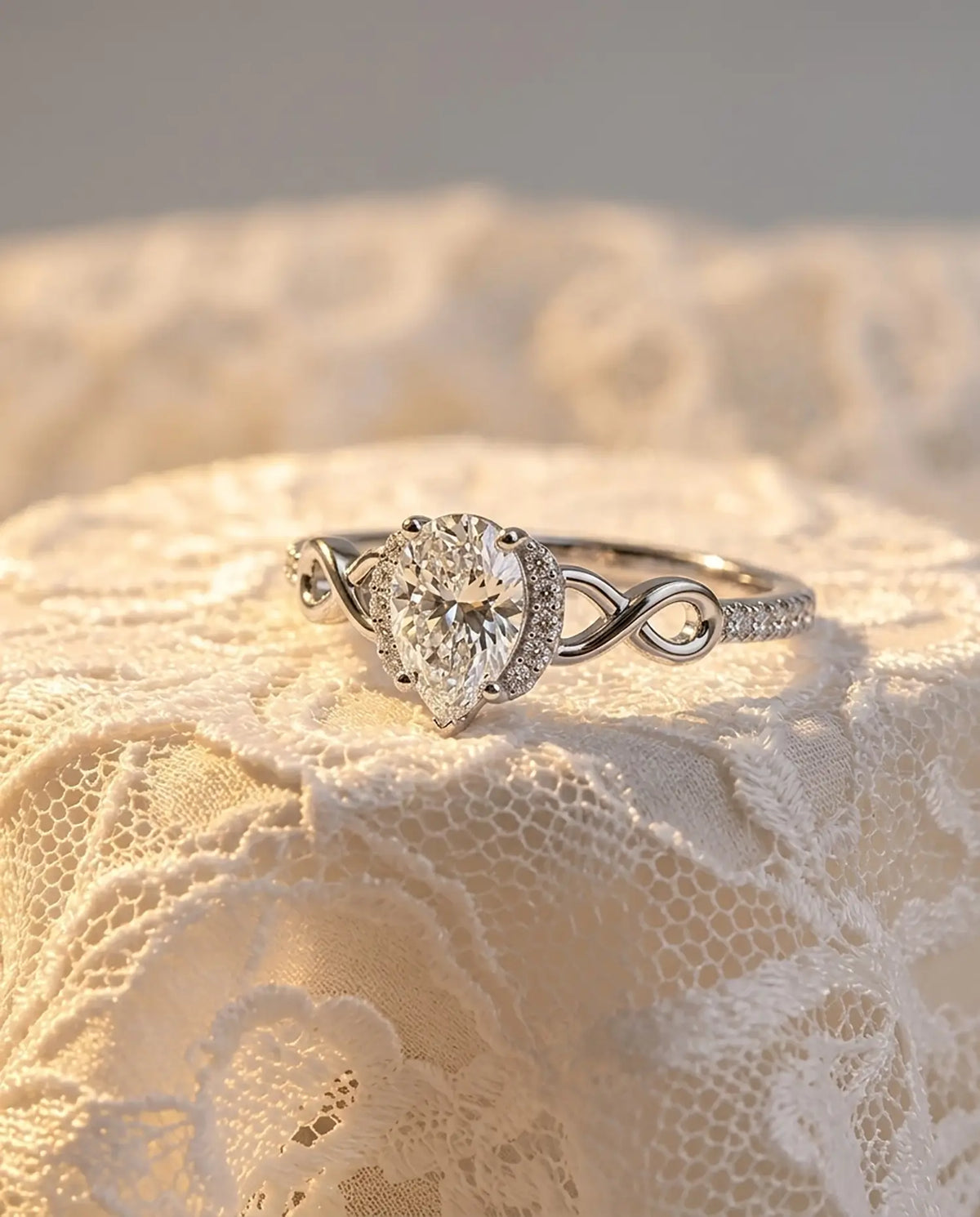 Luxury macro close-up of pear moissanite infinity halo bridal ring placed in an ethereal high-end setting