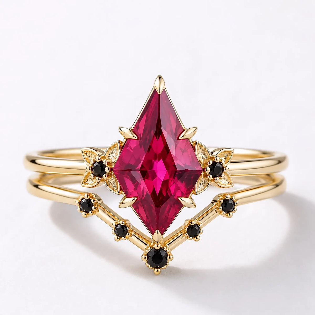 Kite cut ruby floral bridal ring set with black onyx contour band in yellow gold