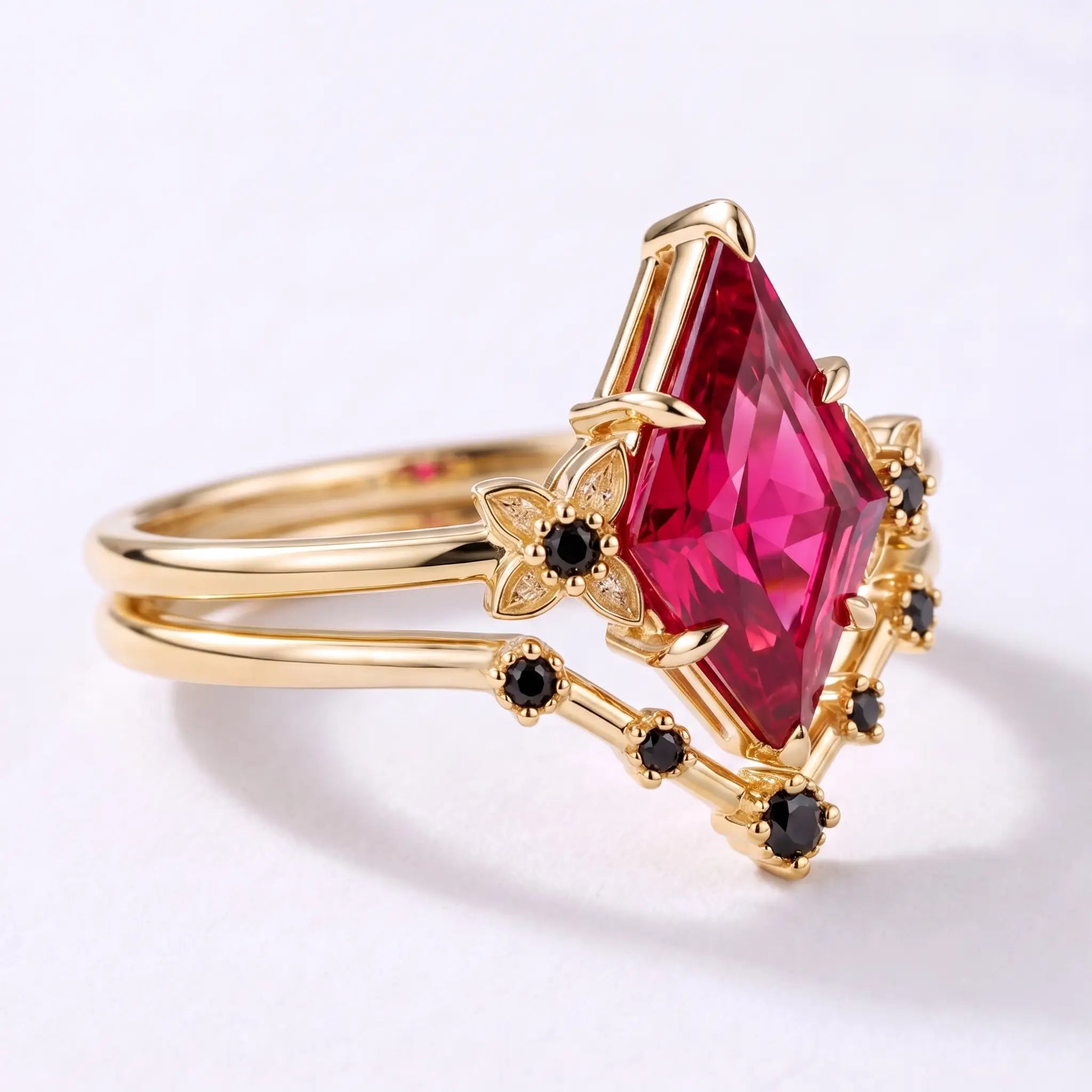 Side view of ruby bridal ring set showing the layered gold band design