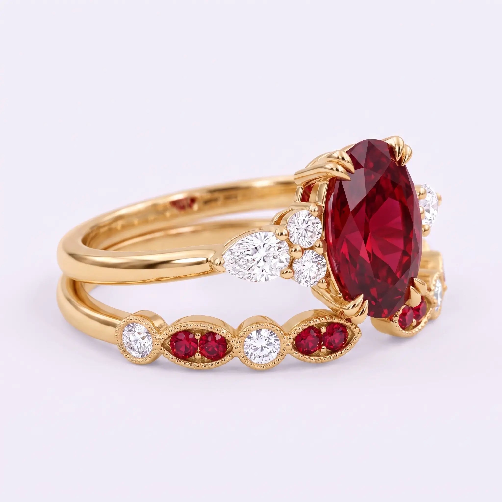 Side view of ruby bridal ring set showing layered band design and oval center stone