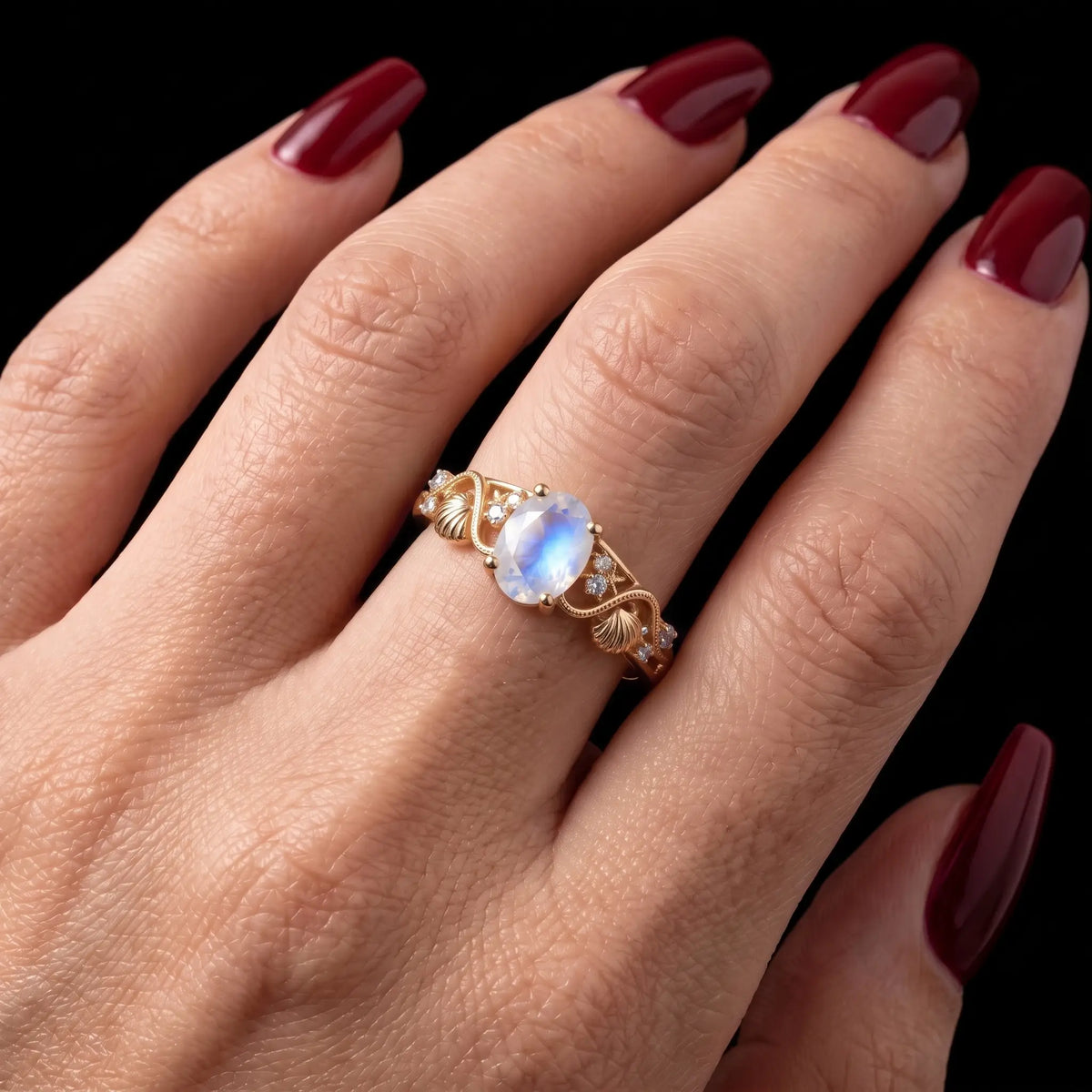 Ocean inspired oval moonstone engagement ring worn on hand