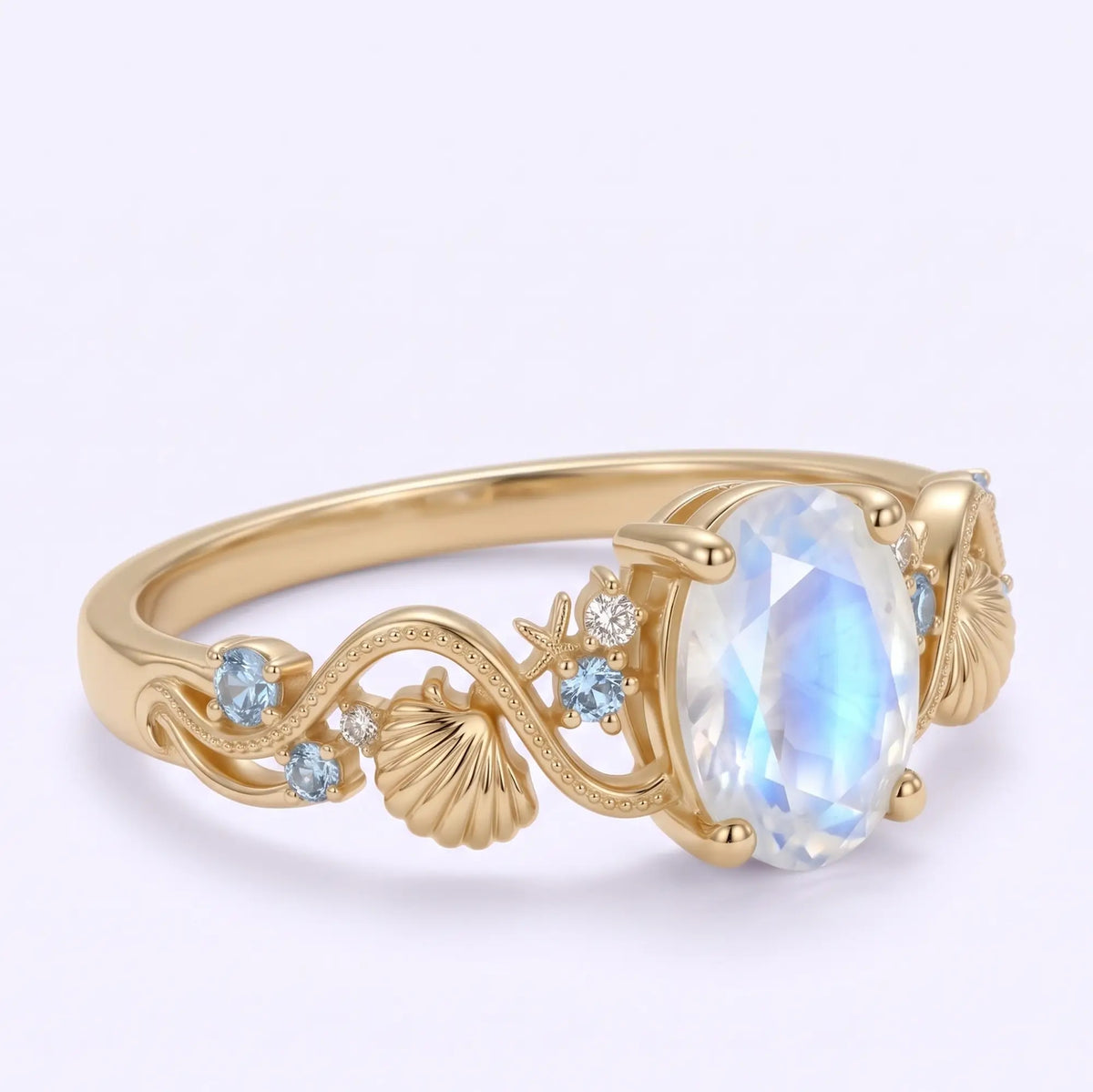Three quarter view of moonstone ring with seashell and starfish details