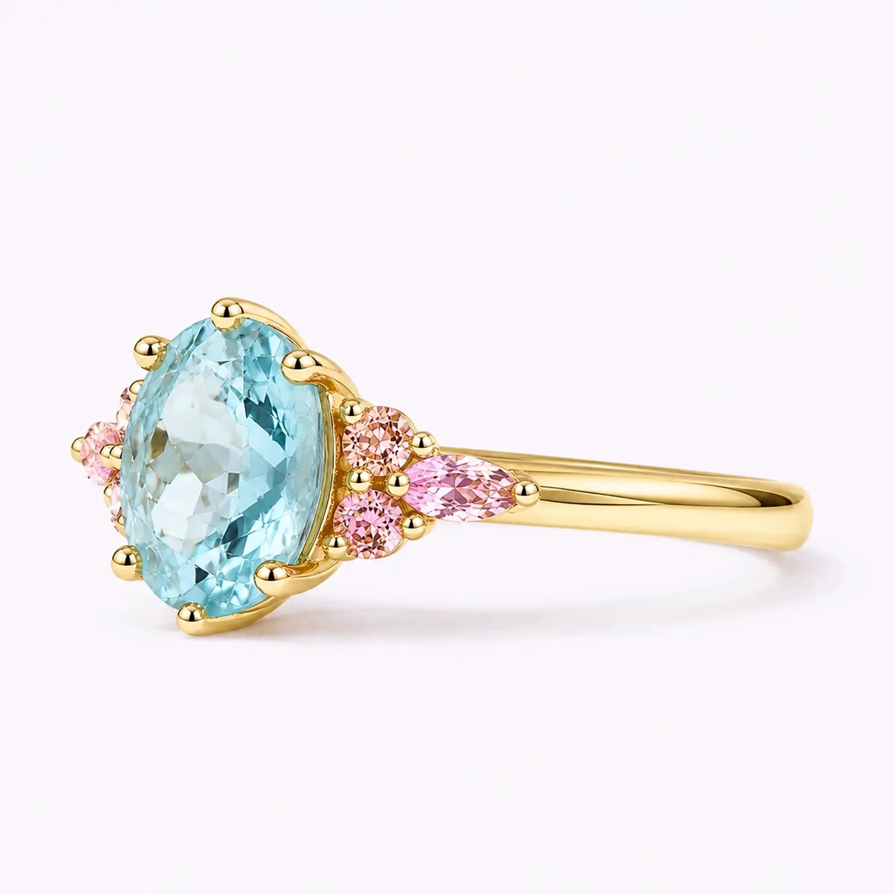 Left view of oval aquamarine ring with pink round and marquise side stones