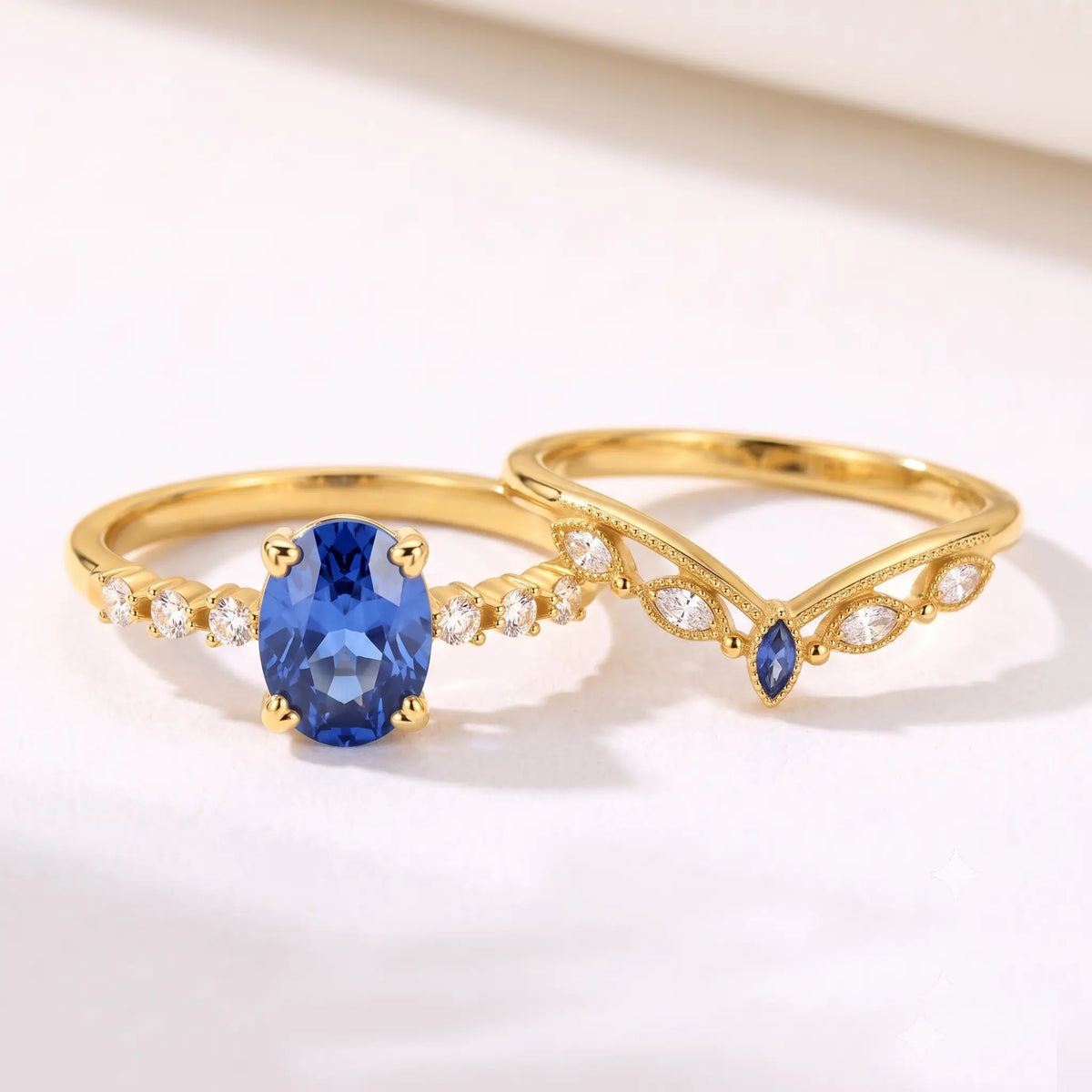 Oval sapphire engagement ring and matching chevron band displayed separately in one frame