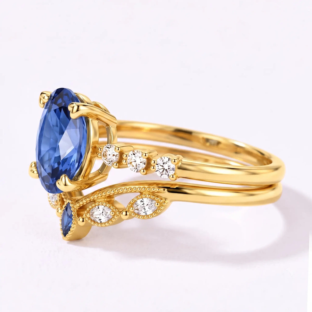 Left view of oval sapphire bridal ring set with curved matching band
