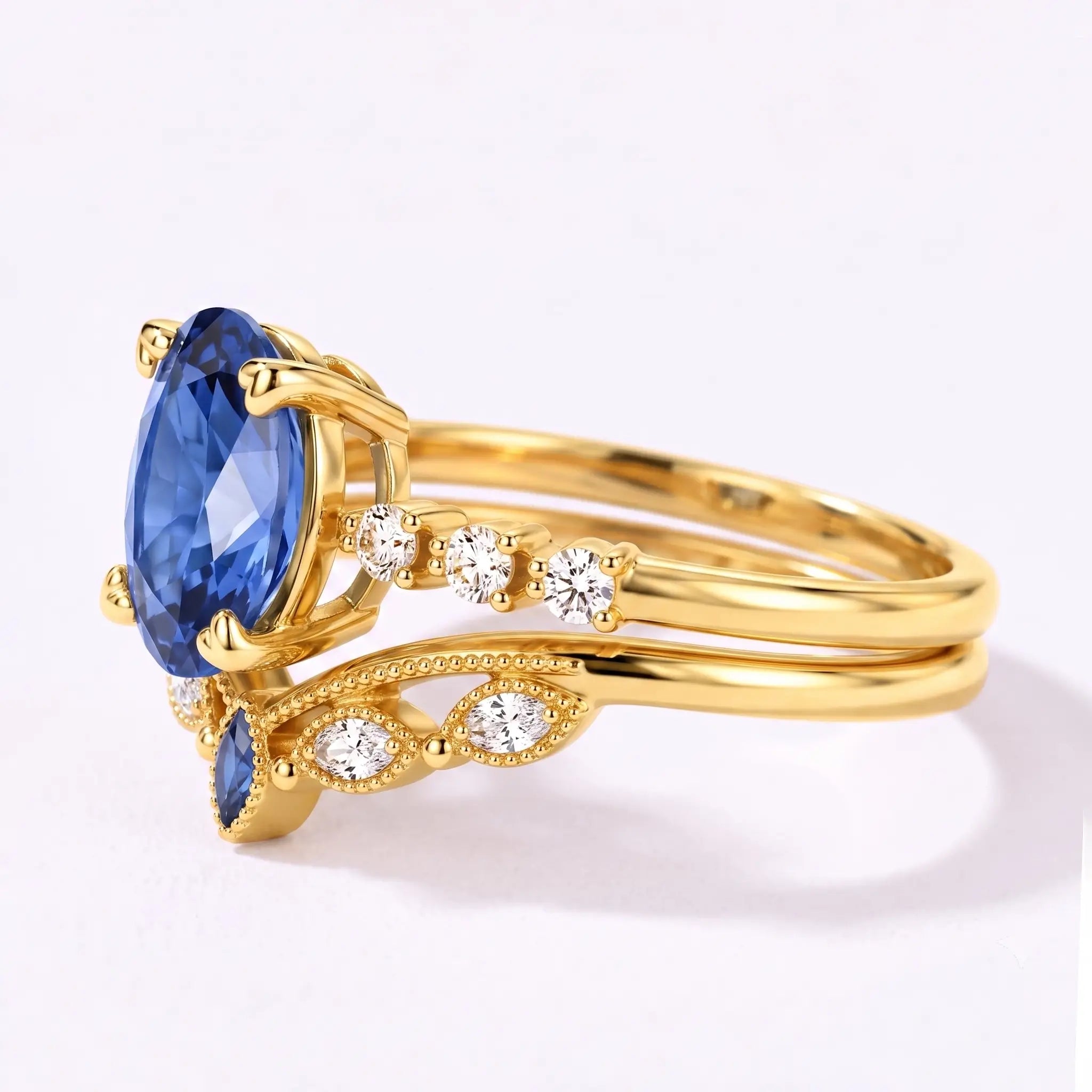 Left view of oval sapphire bridal ring set with curved matching band