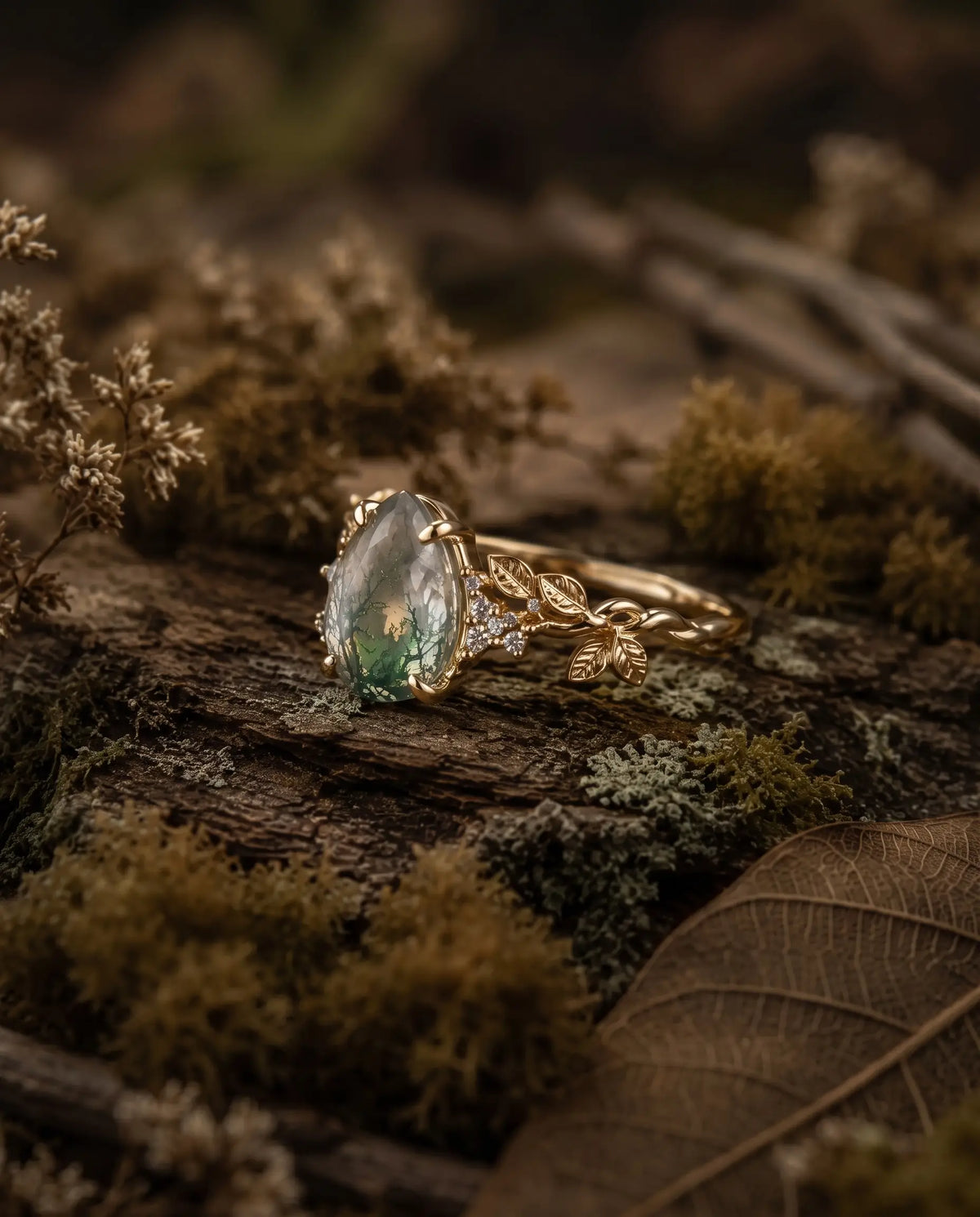 Nature inspired pear moss agate ring worn as an engagement ring