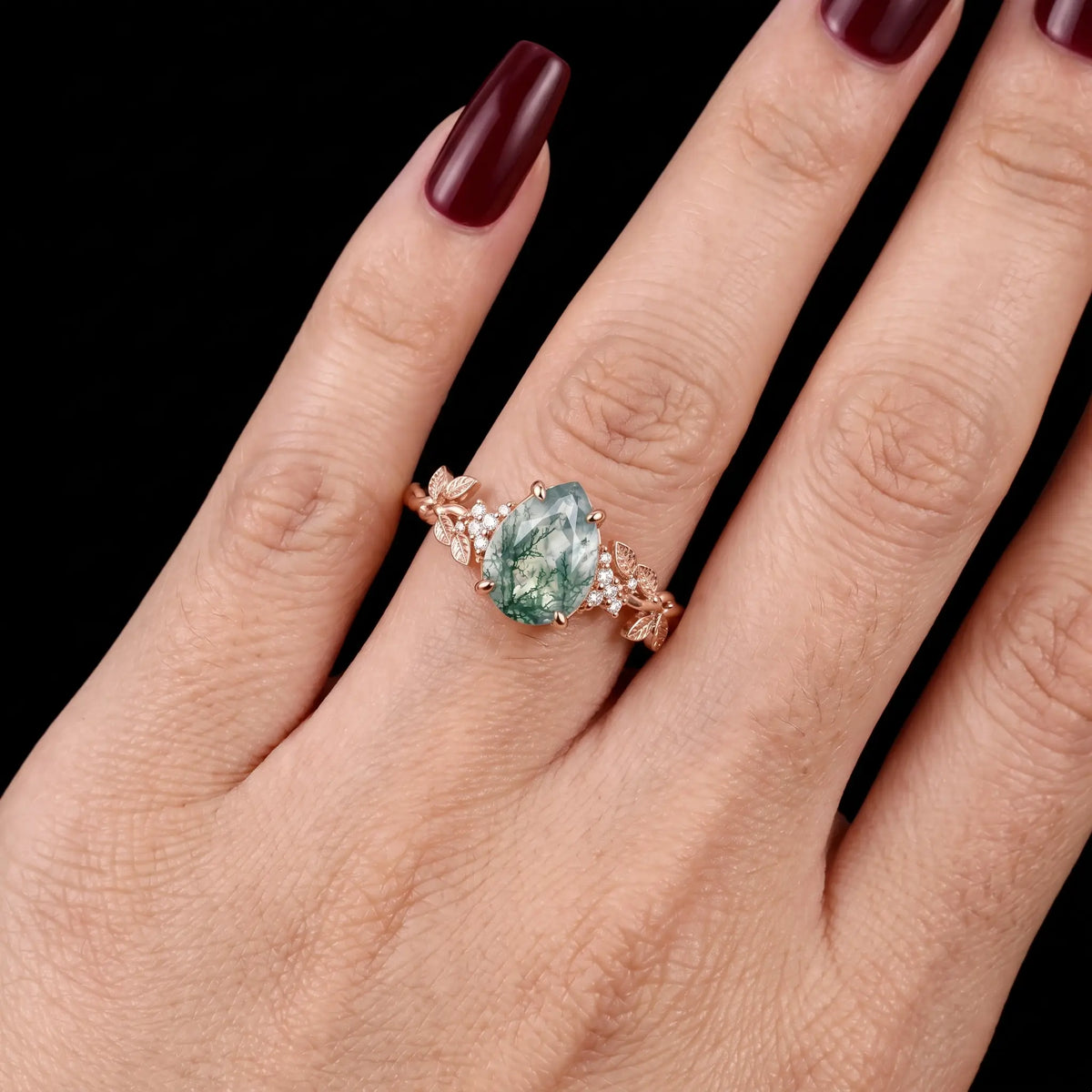 Nature inspired pear moss agate ring worn as an engagement ring