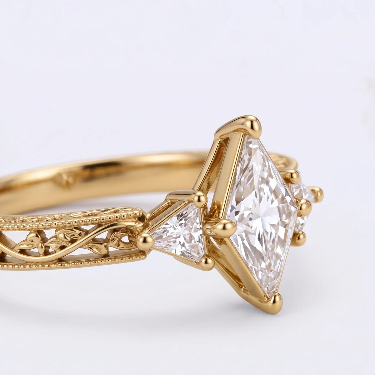 Triangle cut moissanite side stones on a vintage nature inspired three stone engagement ring
