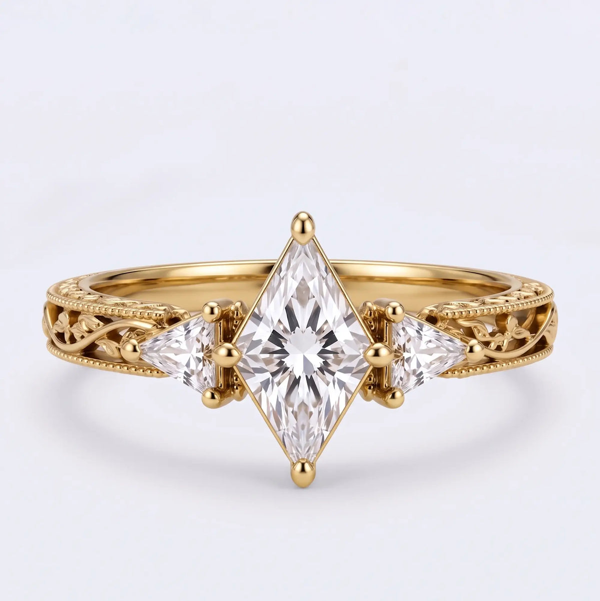 Nature inspired kite cut moissanite three stone engagement ring with triangle side stones and openwork leaf band in yellow gold
