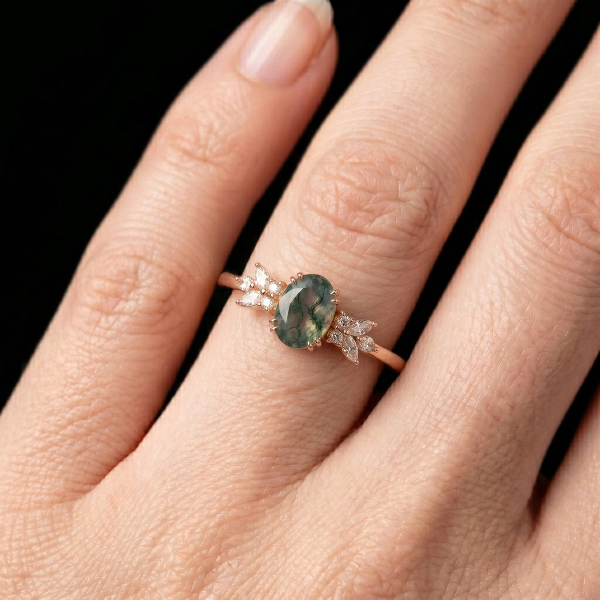 Luminous handmade botanical moss agate ring on hand showing marquise floral brilliance