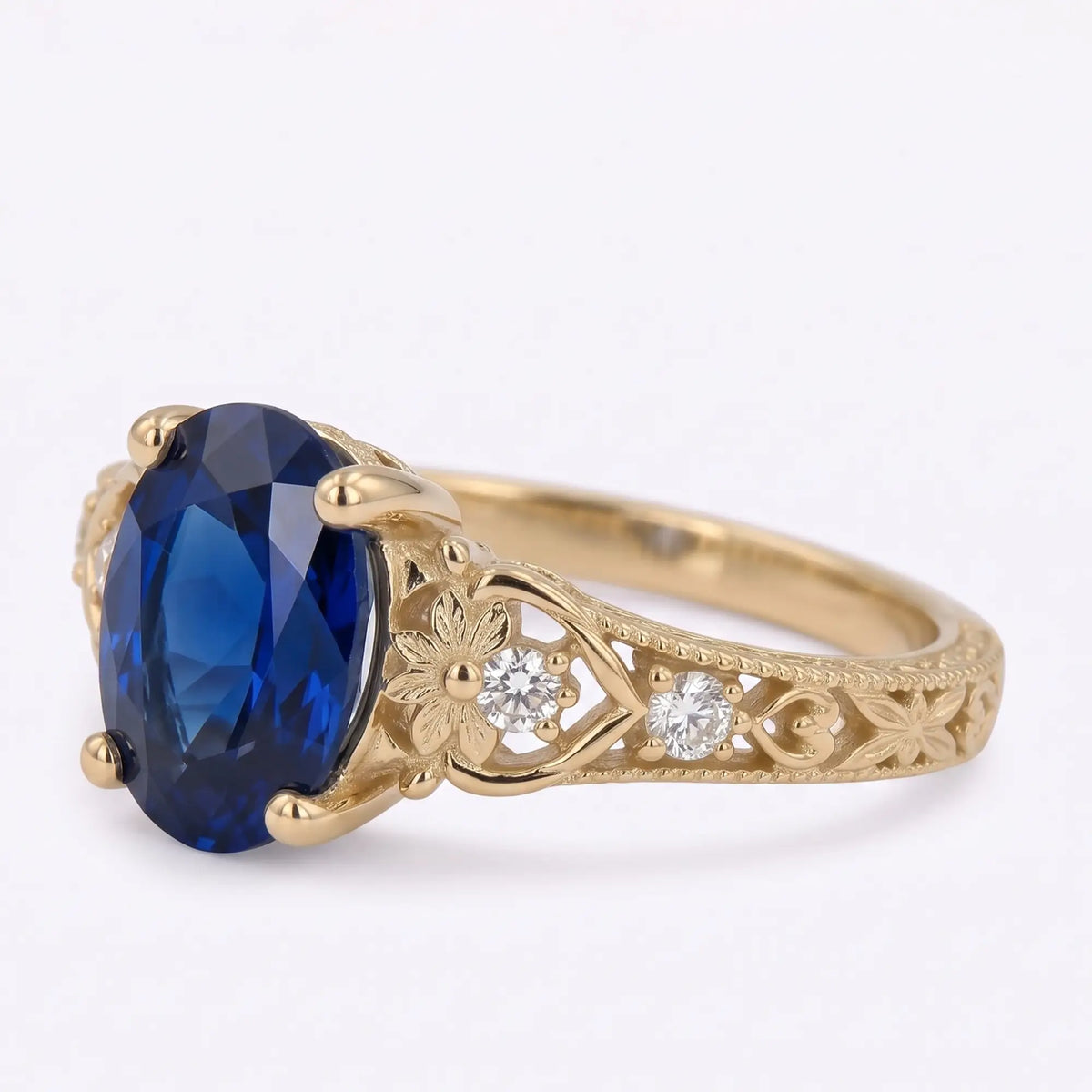 Floral sapphire ring with engraved leaves and botanical openwork shoulders