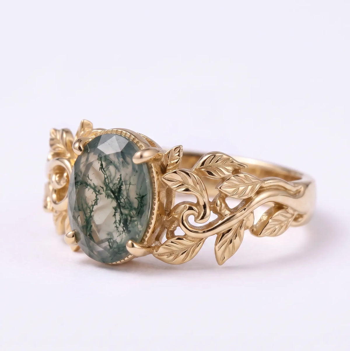 Front view of oval moss agate nature inspired leaf engagement ring