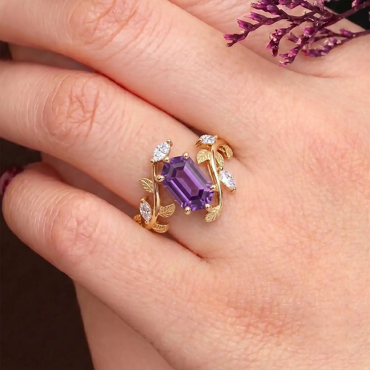 Elongated hexagon sapphire ring worn on hand with organic leaf-inspired design