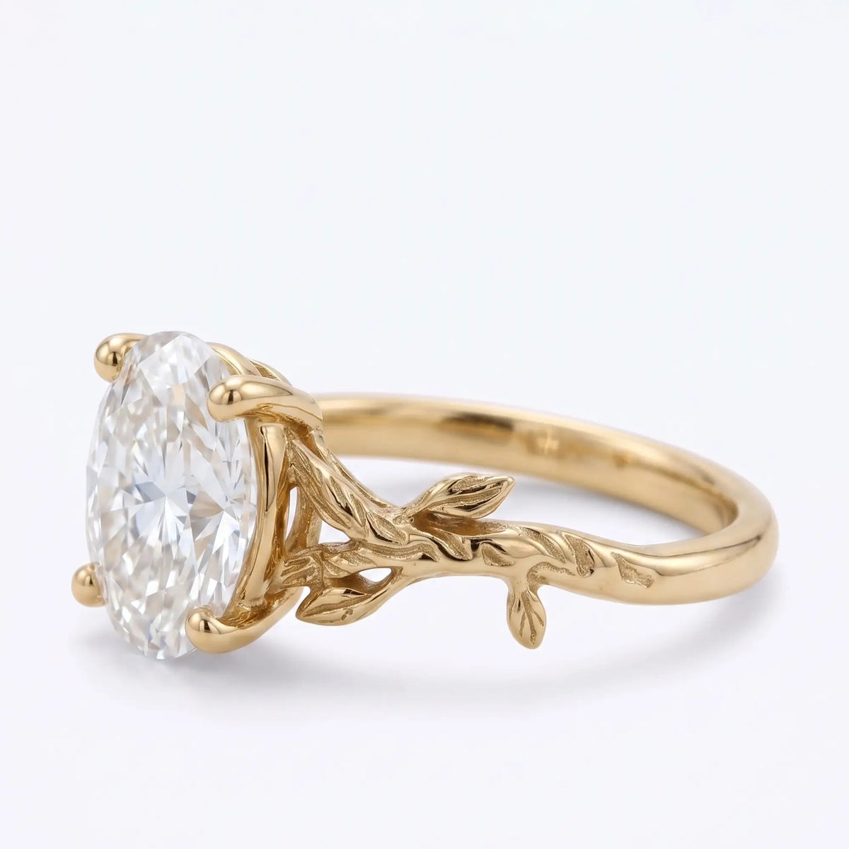 Botanical solitaire ring with oval moissanite and leaf details