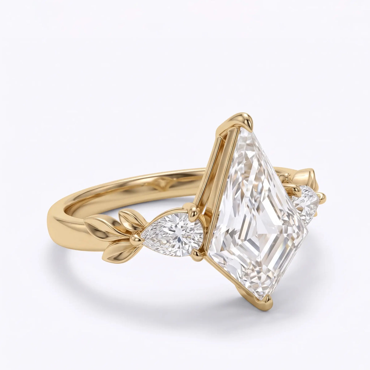 Front view of elongated kite cut moissanite engagement ring with two pear shaped side stones and symmetrical gold leaf details