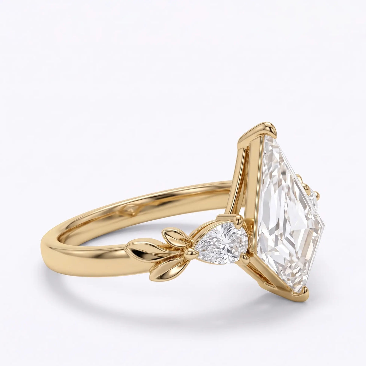 Side profile of a kite shaped moissanite engagement ring highlighting the prong setting and sculpted leaf shoulders