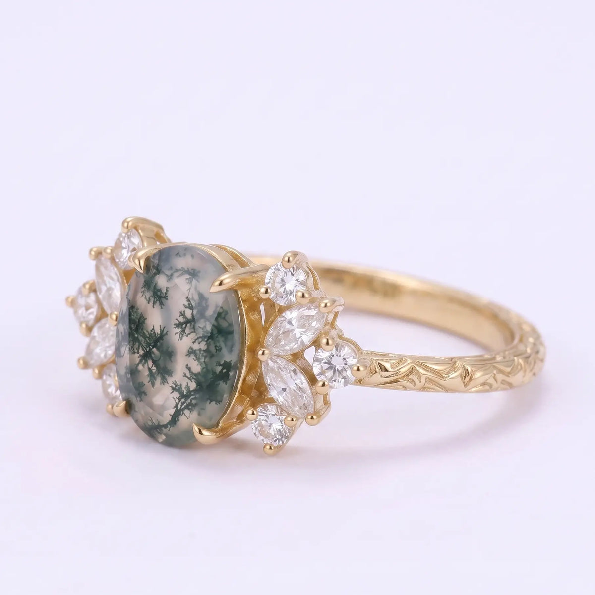 Front view of nature inspired oval moss agate engagement ring with symmetrical cluster design
