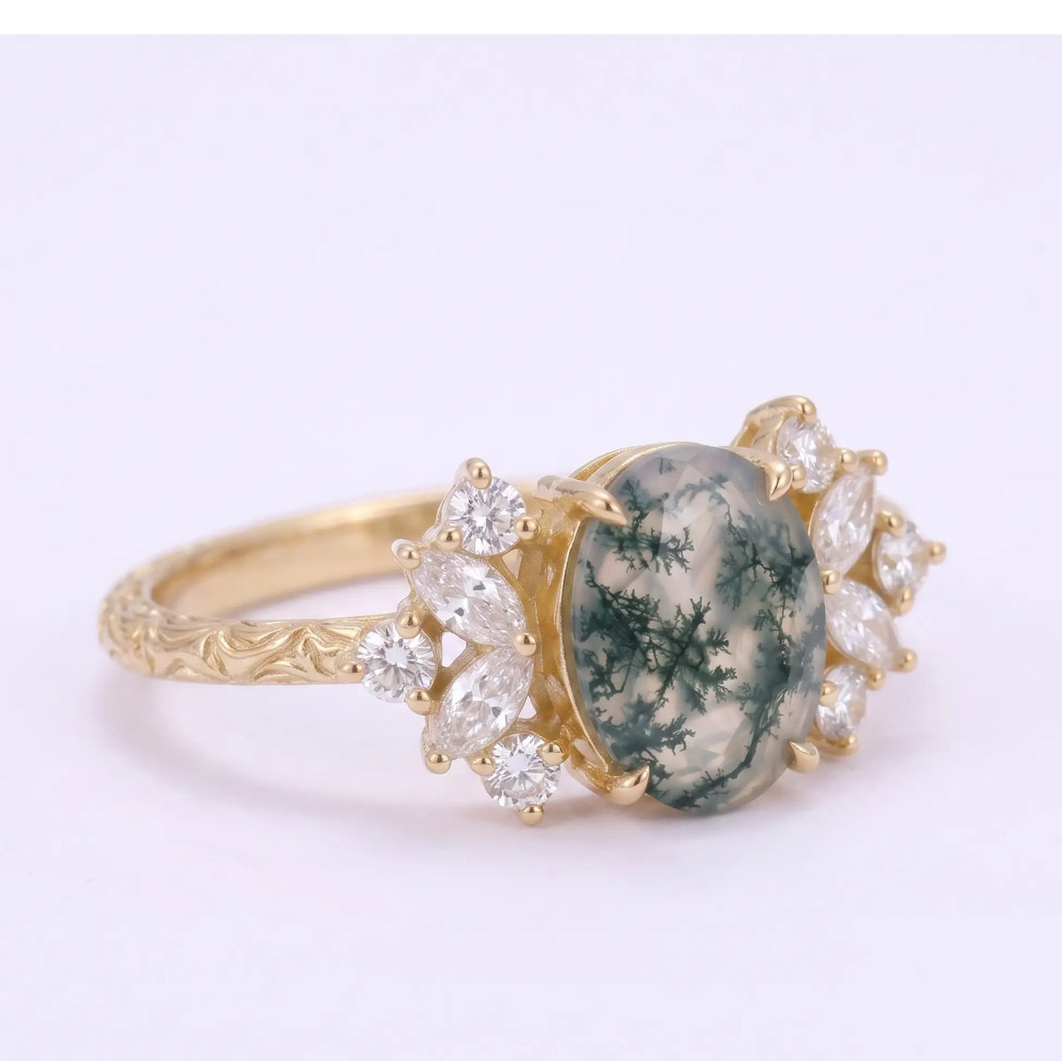 Side angle of moss agate cluster ring with engraved artistic band