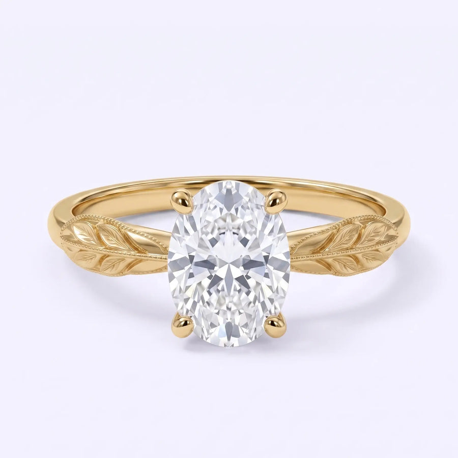 Oval lab-grown diamond solitaire engagement ring with a leaf-inspired gold band