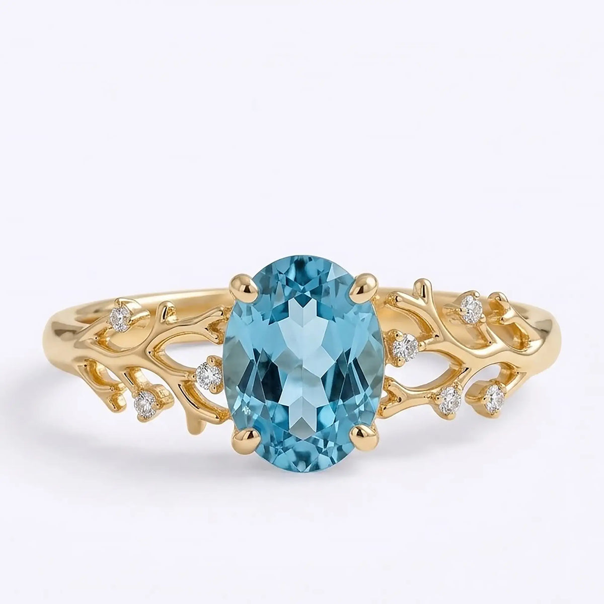 Oval London Blue Topaz coral engagement ring in yellow gold