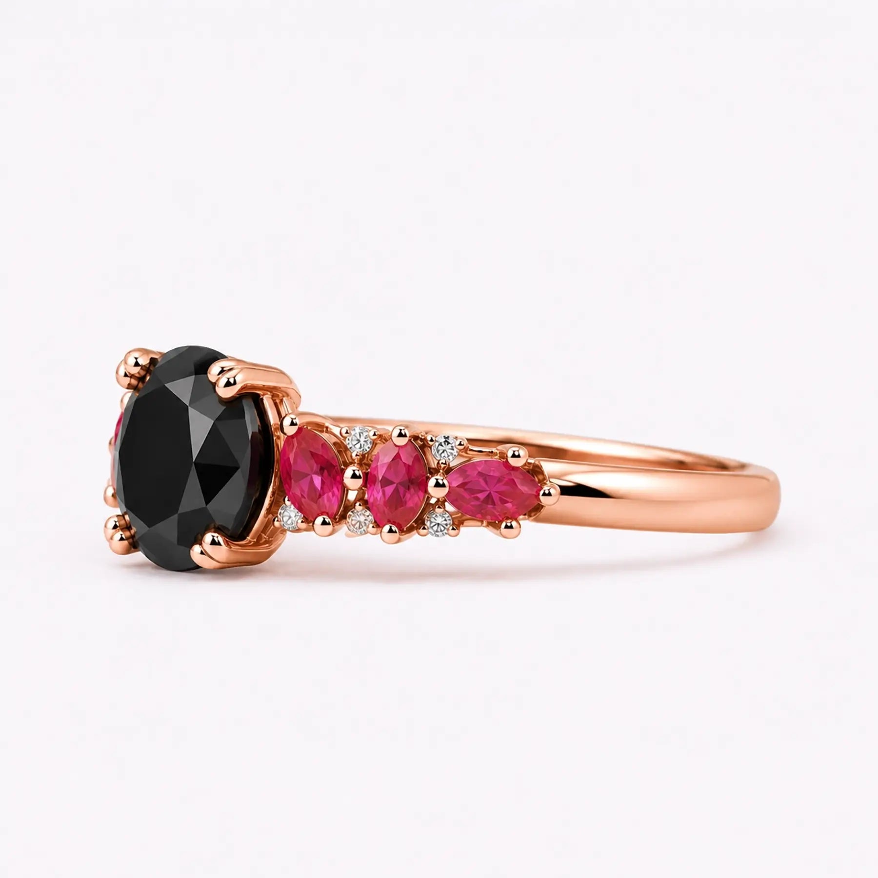 Left view of black moissanite ring with ruby side stones and double round prongs