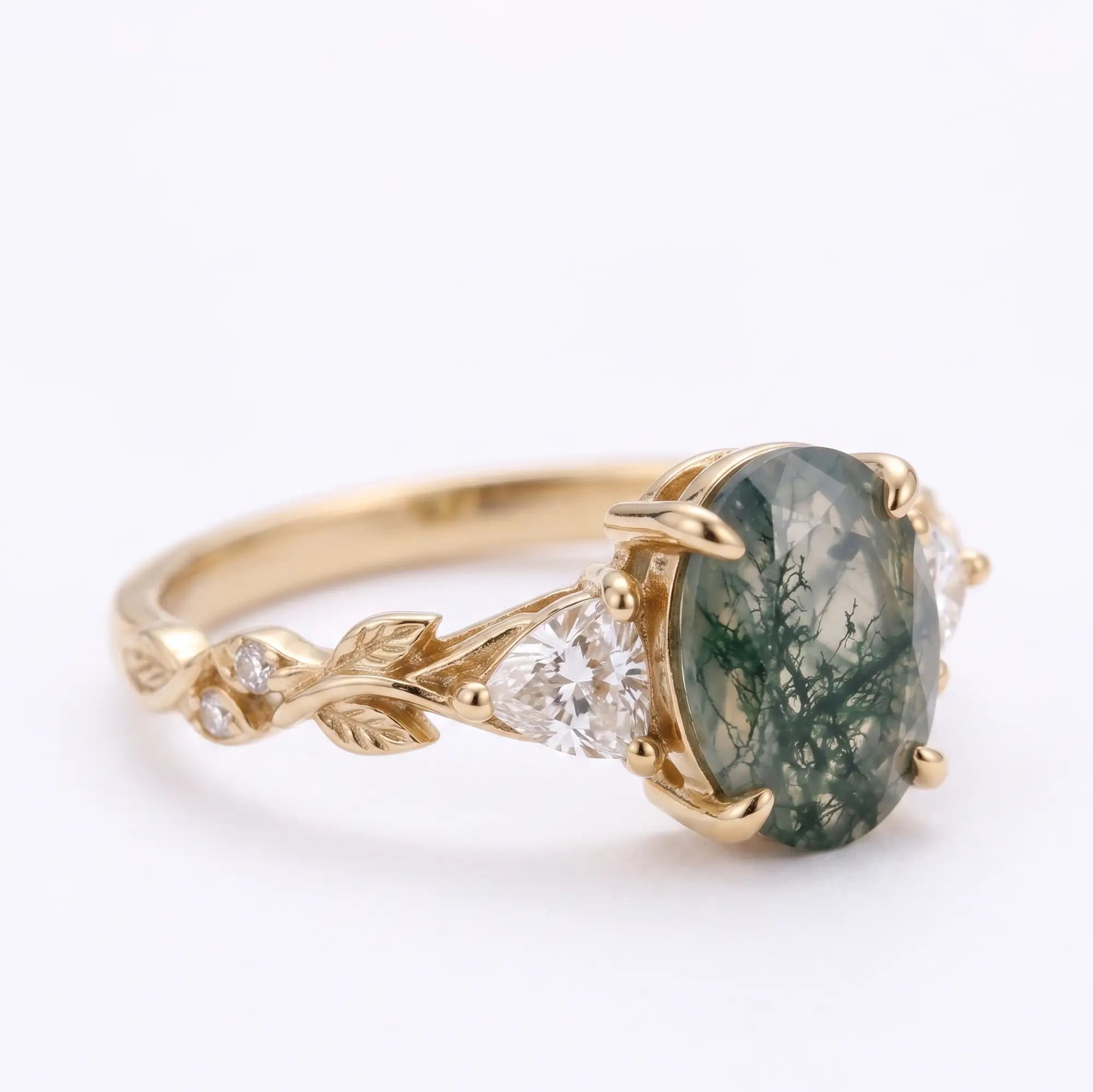 Angle view of nature inspired moss agate three stone ring