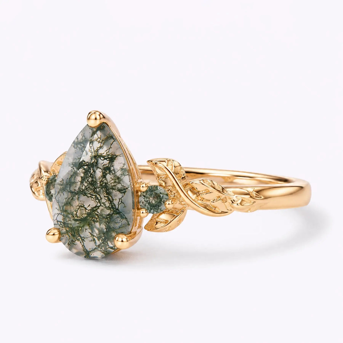 Left view of pear moss agate ring with leaf details and round side stones