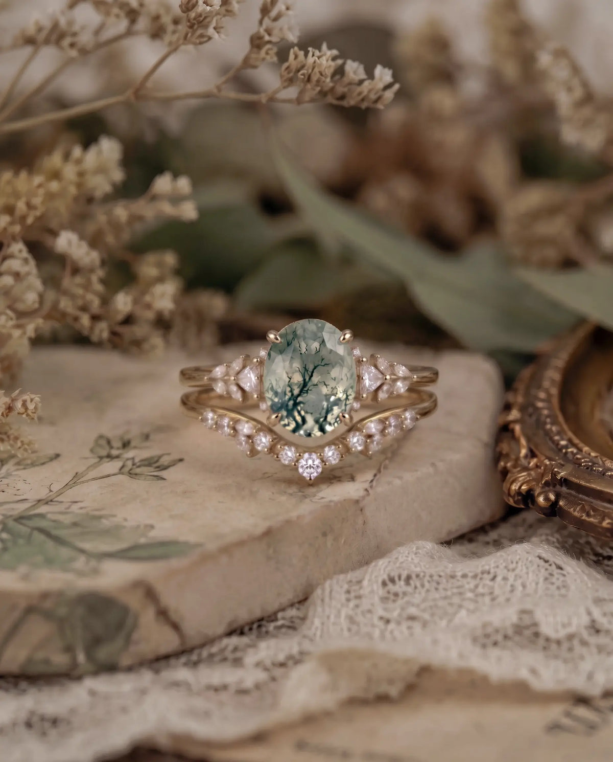 Close-up of oval moss agate bridal ring set with sparkling moissanite accents