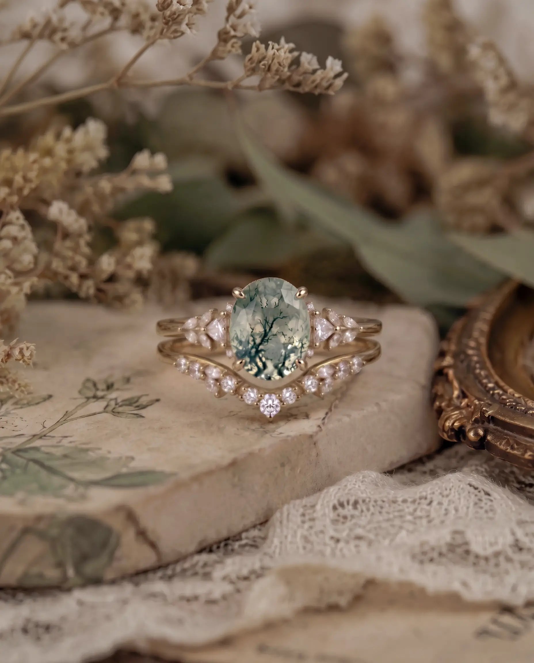 Close-up of oval moss agate bridal ring set with sparkling moissanite accents