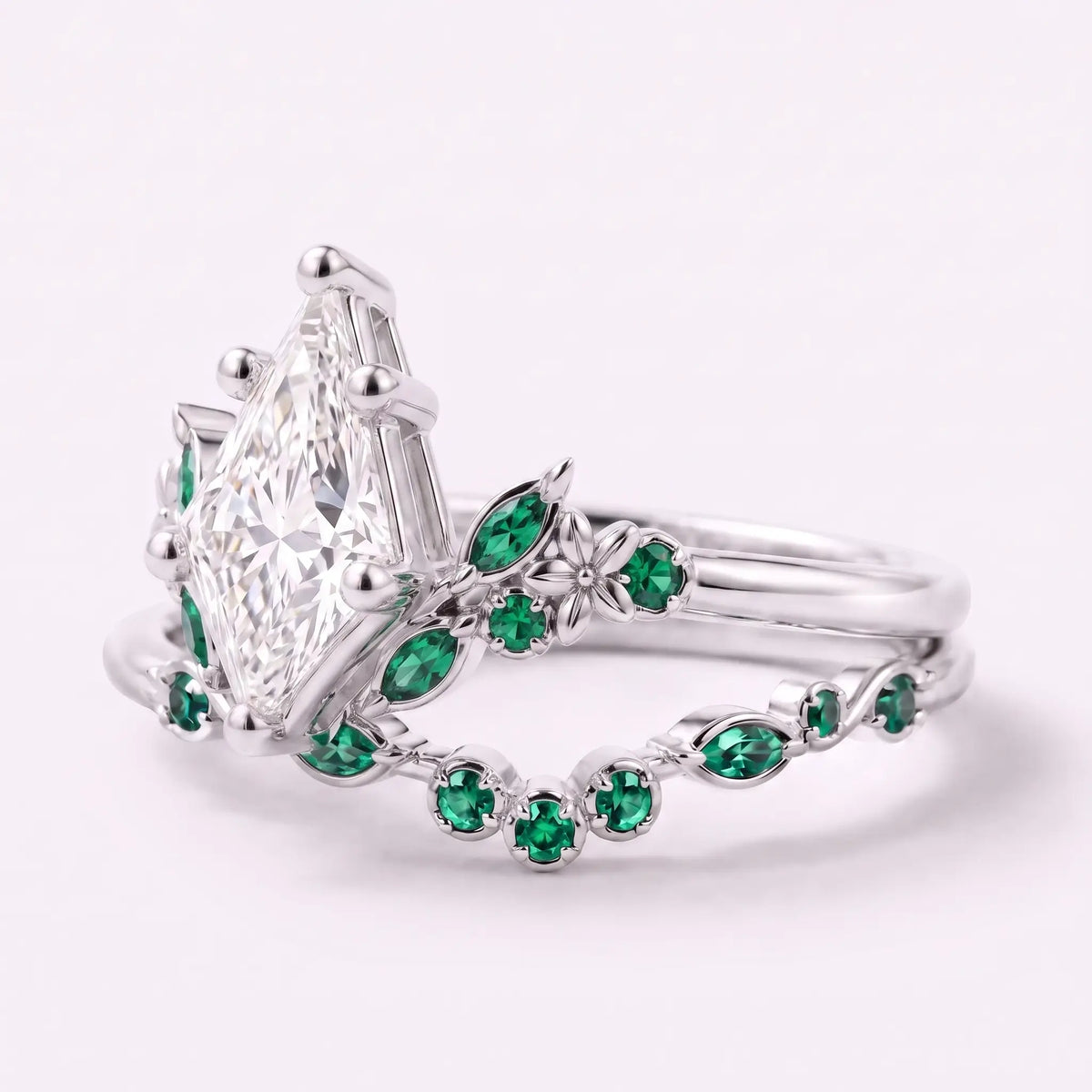 Close-up of kite cut moissanite center stone with emerald round and marquise accents
