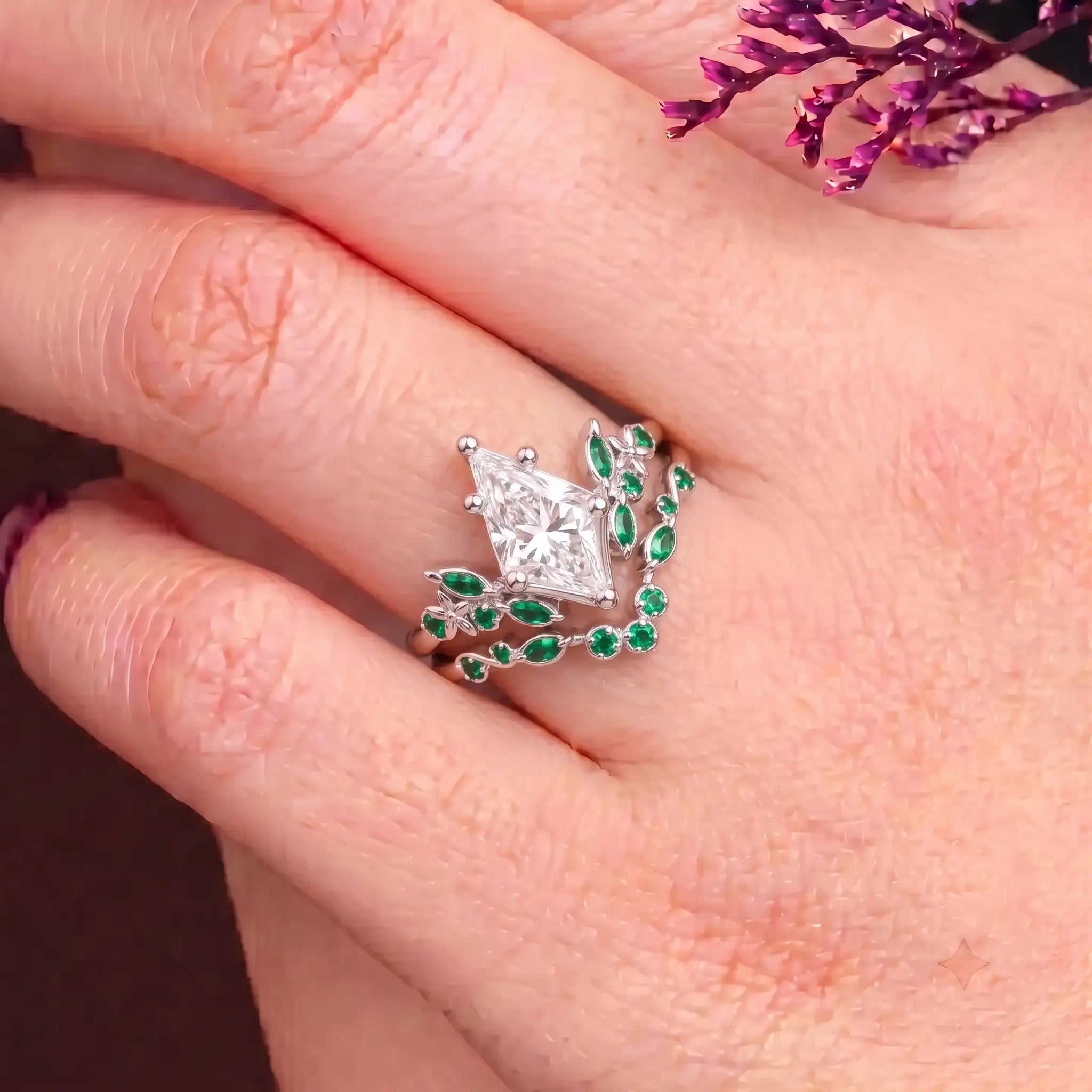 Kite cut moissanite floral bridal ring set worn on hand with matching emerald band