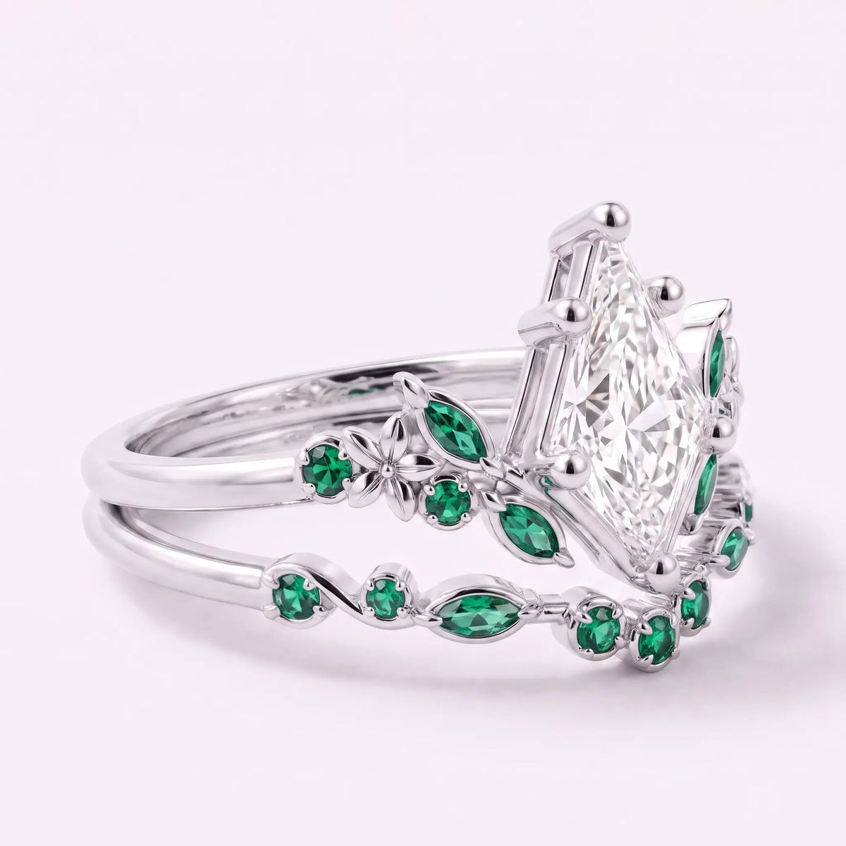 Left view of kite cut moissanite bridal ring set with emerald floral side details