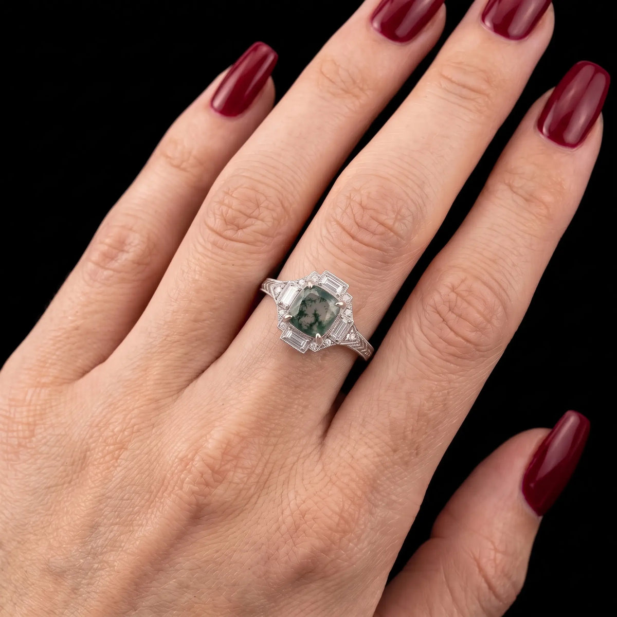 Vintage cushion moss agate halo engagement ring worn on hand