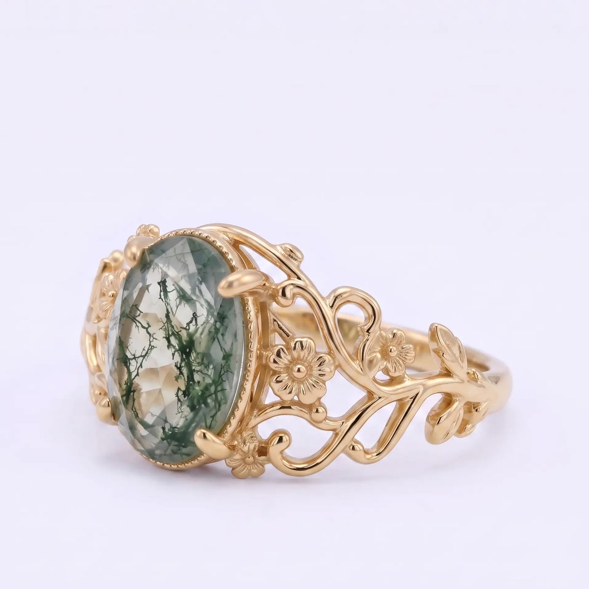Left view of natural moss agate engagement ring with sculpted vines and leaves